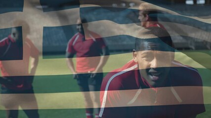 Canvas Print - Animation of Greek flag waving over multi-ethnic male rugby team standing on a pitch