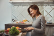 © Viacheslav Yakobchuk - Smiling young lady making healthy breakfast in the kitchen