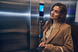 © Svitlana - Successful business lady going down in elevator