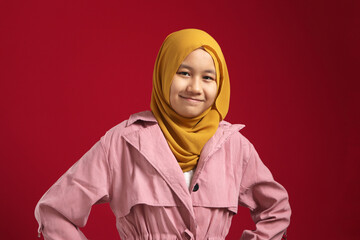 Wall Mural - Portrait of young happy confident muslim teenage girl wearing yellow hijab looking at camera and smiling cheerfully