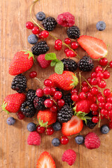 Canvas Print - assorted of fresh berries fruits on wood background