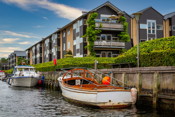 Photo of Copenhagen tourist landmark spot taken during a boat ride across the city canals, on a hot summer day with bright sky.