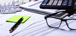 © Елена Дигилевич - Workplace with reports, calculator, glasses and pen. Business concept
