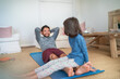 © trevor adeline/Caia Image - Playful father and daughter exercising in living room