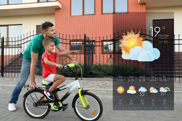 Wall Mural - happy father teaching his son to ride bicycle and weather forecast widget. mobile application