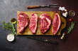 © Anastasia Nurullina/ADDICTIVE STOCK - Top view of raw black angus prime beef steaks on wooden cutting board: rib eye, chuck roll, striploin and picanha.