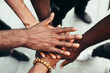 © Victor Torres/ADDICTIVE STOCK - Group of friends stacking hands against racism. Black Lives Matters concept.