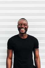 Happy Black Man Posing And Smiling Over White Background