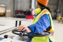 Female Ground Crew Worker Driving Luggage Cart