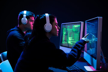 caucasian man and a woman working late in an office