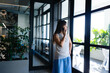 © wavebreak3 - Asian woman having a phone call and looking outside