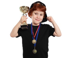 Child athlete winner of the competition. Portrait of a beautiful red-haired boy 5 years old on a white background. A boy with a gold Cup and medals for first place in the competition. Little champion.