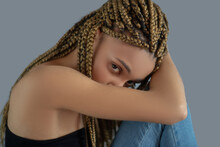 Sad Young African American Holding Her Knee, Hiding Her Head In Her Arm