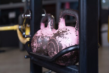 Close Up Of Pink Kettlebells In A Row At A Gym. Sport Equipment In Fitness Center.