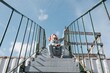 © Cavan Images - young girl sitting on the stairs shouting out loud whilst outside