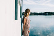 © Cavan Images - young girl with a feather headband looking out to sea whilst playing