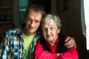 Poster - Portrait of a man embracing his grandmother.