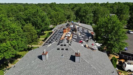 Wall Mural - East Brunswick NJ US. 20 JUNE 2020: Roof repairs old roof replacement with new shingles of an apartment building