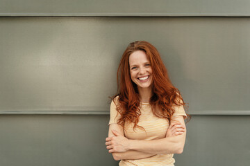 Wall Mural - Relaxed happy young woman laughing at camera