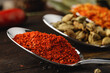 © fotofabrika - Spoon with spices on dark wooden table close up