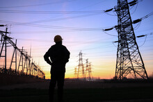 Electricity Workers And Pylon Silhouette, Power Workers At Work