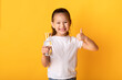 Portrait of cheerful asian child drinking fresh water