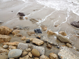 Wall Mural - Beach surf coastline sand foam rocks stone