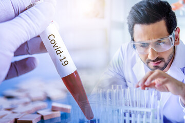 Wall Mural - scientist lab technical service observe liquid sample with lab glassware, microscope and test tubes 