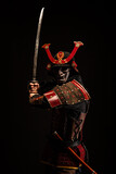 Fototapeta Sawanna - Portrait of a samurai in armor in attack position