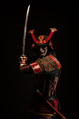 Portrait of a samurai in armor in attack position