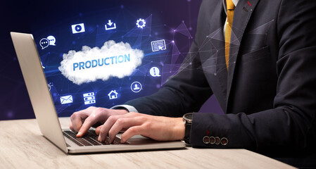businessman working on laptop with production inscription, modern technology concept