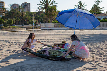 Two girls putting towel