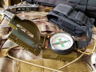 compass, knife and multitool in a backpack
