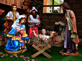 Statuettes of Mary, Joseph and baby Jesus,The birthday of Jesus is a statuette of Maria with Joseph and newborn Jesus on the hay, A Christmas nativity scene.