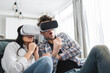 © LIGHTFIELD STUDIOS - Selective focus of scared young couple using vr headsets on couch