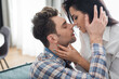 © LIGHTFIELD STUDIOS - Beautiful woman kissing handsome boyfriend at home