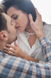 © LIGHTFIELD STUDIOS - Selective focus of beautiful woman kissing and touching neck of boyfriend