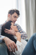 © LIGHTFIELD STUDIOS - Selective focus of handsome man hugging and touching hair of attractive woman at home