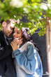 © LIGHTFIELD STUDIOS - Selective focus of man touching face of smiling girlfriend near tree outdoors