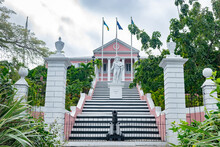 Nassau, Bahamas. The Government House, Painted In Pink, With Statue Of Christopher Columbus On The Staircase