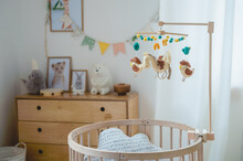 Baby Room With Round Crib And A Mobil 