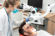 © Proxima Studio - Dentist checking up patient teeth with microscope