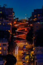 High Angle View Of Illuminated Homes On Lombard Street In San Francisco, California At Sunset With Car Light Trails