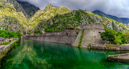 Wall Mural - Emerald green waters of Kotor Bay or Boka Kotorska and the ancient wall of Kotor former Venetian fortress in Montenegro