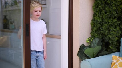 Wall Mural - young boy opens sliding door to the patio