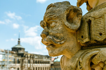 Sculpture made of sandstone in blurred background in the famous Baroque Zwinger in Dresden's old town.