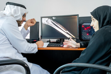 arabic muslim doctor and his patient discussing x-ray photo