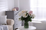 Fototapeta Koty - Bouquet of beautiful peony flowers on table indoors