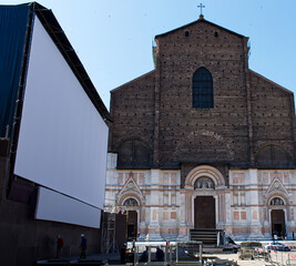 Outdoor cinema with white projection screen in Piazza Maggiore.