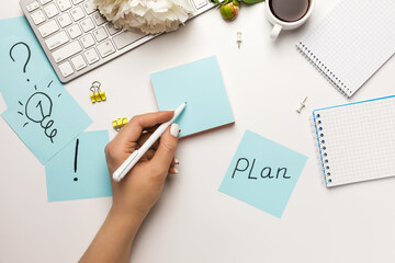 Pictogram marks on sticky notes on office desk on white background top view.